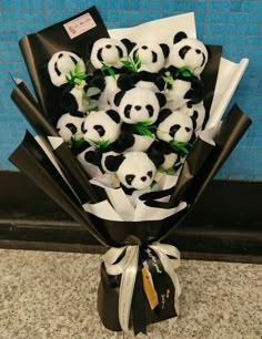 a bunch of stuffed panda bears sitting in a bouquet