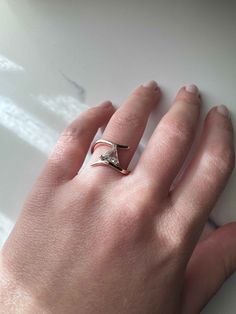 a person's hand with a ring on it