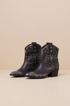 The Dirty Laundry Nowhere Black Distressed Studded Western Ankle Boots will have you channeling your cool inner cowgirl! Distressed faux leather (with a white-washed faded effect) shapes a pointed-toe upper that rises to a seamed vamp and an ankle-high shaft with Western-inspired embroidery and gunmetal studs throughout. The slip-on design features a classic, curved topline with pull tabs at both sides, all atop a stacked block heel. Please note: These boots are intentionally designed to include pre-worn distressing for a trendy lived-in look.   2. 25" stacked block heel. Lightly cushioned insole. Rubber sole has nonskid markings. Man Made Materials. Imported. Lulus | Nowhere Black Distressed Studded Western Ankle High Heel Boots | Size 6. Western Ankle-high Moto Boots For Spring, Leather Boots For Western-themed Summer Events, Western Ankle-high Boots For Summer, Western Style Moto Ankle Boots For Spring, Spring Western Ankle Moto Boots, Western Style Moto Boots For Spring Events, Western-style Moto Boots For Spring, Western Ankle Boots, Shoes Boots Ankle