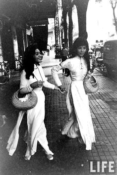 two women are walking down the street together