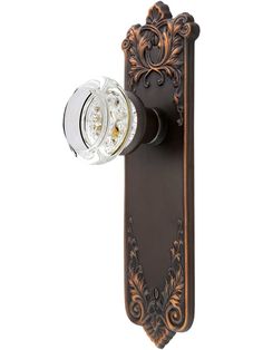 an old fashioned door handle with a clock on the front and back side, is shown