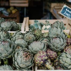 an assortment of artichokes for sale at a market