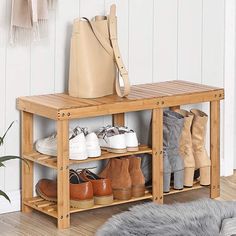 a wooden shoe rack with shoes on it and a plant in the corner next to it