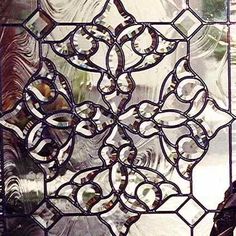 a decorative glass window with an intricate design