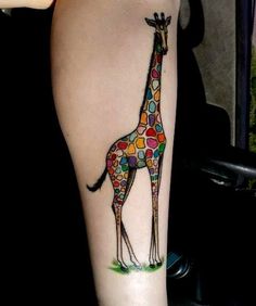 a giraffe tattoo on the leg of a woman's right arm, with dots all over it