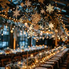 a long table with candles and snowflakes hanging from the ceiling