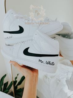 -This is a custom Groom's sneaker.  -Option 1 is only Name and date -Option 2 has painted outer 2 swooshes and names and dates. -Offers more designs and colors per request /check out my store/ -Open for custom requests. TURNAROUND TIME: -2 weeks to be crafted just for you -Shipping will take an additional 3-7 business days. -We offer FREE shipping within the US. -EXPEDITED service available Visit the link below for EXPEDITED SERVICE: https://perfctpairings.etsy.com/listing/1537883783 for PURCHAS Wedding Nikes Bride And Groom, Custom White High-top Wedding Sneakers, White High-top Wedding Sneakers, Sneaker Wedding, Groomsman Cake, Nike Air Jordan Mid, Wedding Shoes Sneakers, Air Jordan Mid, Jordan Mid