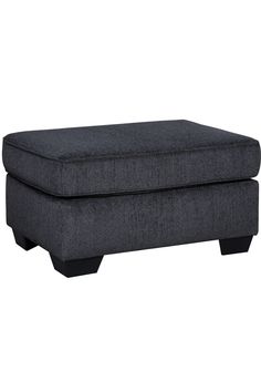 a gray ottoman sitting on top of a white floor