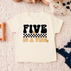 a white t - shirt with the words five is a vibe printed on it next to a teddy bear