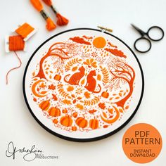 an orange and white plate sitting on top of a table next to scissors, thread and yarn