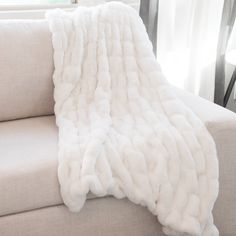 a couch with a white blanket on top of it