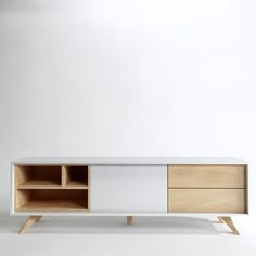 a white and wood entertainment center with two open shelves on each side, in front of a plain wall