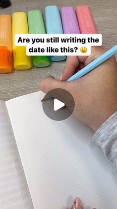 someone is writing on a notebook with colored crayons in the background and text that reads are you still writing the date like this?