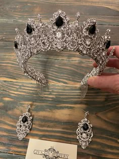 Radiant crystal beauty set. The height of this crown is 6 centimeters. Created from delicate metal filigree, pure and black shining rhinestones. A gorgeous crown will adorn any girl as a queen, and elongated drop earrings will give out graceful facial features. It was created in a composition and perfectly combined The crown is securely fastened with additional crests All of our products are handmade. So you can be sure of its non-repeatability You can also see products that fit as a set. This t Black And Silver Crown, Black Quinceanera Crown, Black Swan Quince, Black Quince Crown, Ball Accessories, Black Crowns, Black And Silver Quince, Sweet 16 Crowns, Quince Crown