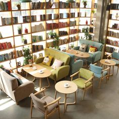 a room filled with furniture and bookshelves covered in shelves full of bookcases