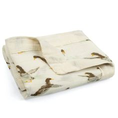 a white blanket with birds on it