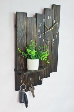 a wooden wall clock with plants and keys on it