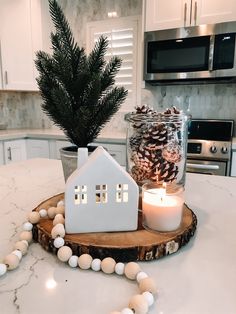 a candle is sitting on top of a wooden slice in the middle of a kitchen