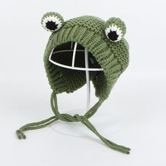 a green knitted hat with eyes and ears