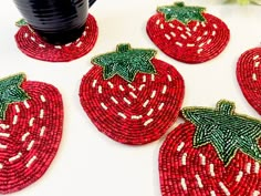 red beaded coasters with strawberries on them