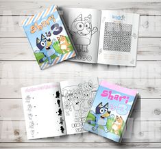 three children's coloring books on a white wooden background with the same book title