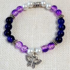 Pretty Butterfly Purple & White Glass 8mm Beaded Stretch Bracelet. Comes In Cellophane Packaging. Bundle & Save! Thanks For Stopping By! Posh On! Blue Beaded Bracelets Diy Jewelry, Navy Blue Bracelet, Glass Bead Crafts Jewellery, Glass Bead Jewelry Ideas, Glass Bracelet Ideas, Glass Beaded Bracelets Ideas, Bracelet Ideas Glass Beads, Purple Bracelet Ideas, Glass Beads Bracelet Ideas