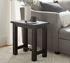 a living room with a gray couch and coffee table