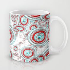 a coffee mug with red and blue swirls on it