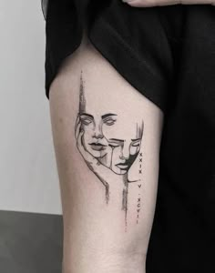 a woman's arm with two faces drawn on it