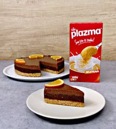 two plates with slices of cake on them next to a box of plazma