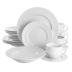 white dishes and cups are stacked on top of each other