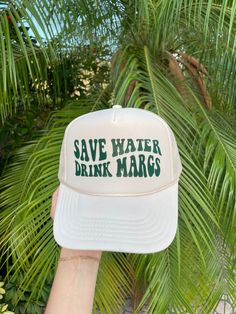 someone is holding up a hat that says save water drink margs