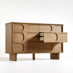 a wooden dresser sitting on top of a white floor