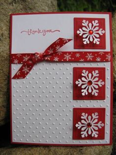 a red and white card with snowflakes on it