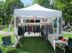 a tent with clothes hanging on it in the grass