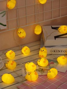 some yellow lights that have been placed on a table with other items in front of them