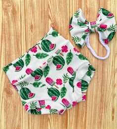 two pieces of cloth with strawberrys and green leaves on them, one has a headband