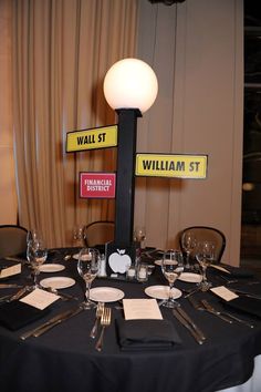 a table set up with place settings and signs