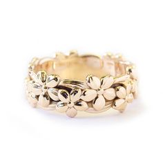 a gold ring with flowers on it