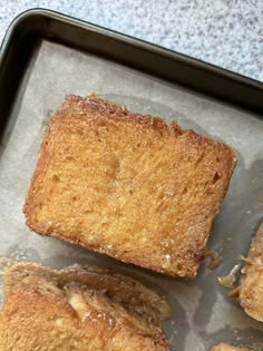 three pieces of bread sitting on top of a pan