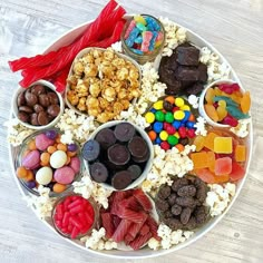 a plate filled with lots of different types of candies and chocolates on top of it