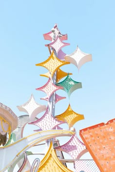 a large metal structure with many different colored kites attached to it