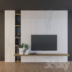 a flat screen tv sitting on top of a wooden shelf in front of a white wall