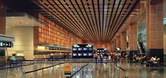 an airport terminal with people waiting for their luggage