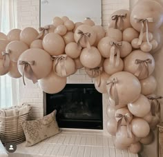 a fireplace with balloons attached to it in front of a mirror and fire place mantle