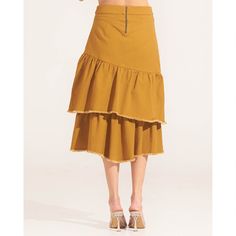 Morrato Bali's Bailey Midi Skirt captures the brand's bohemian spirit. It's cut from durable cotton to a tiered asymmetric silhouette and decorated with unfinished hemline details. Wear yours with the Bailey Jacket for a chic Wild West look.  Midi length Asymmetric cut Two-tiered skirt Ruffled trim Raw-cut hem Back zip fastening 100% Cotton Wash colors separately Do not bleach Do not tumble dry Warm iron if needed Brand Magazine, Ethical Brands, Artisan Gift, Blazer With Jeans, Tiered Skirt, Independent Designers Fashion, Ethical Fashion, Fashion Labels, Wild West