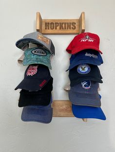 several hats are hanging on a rack in front of a sign that says hopkins