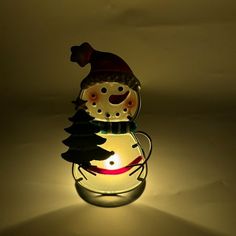 a lit up glass jar with a snowman on it