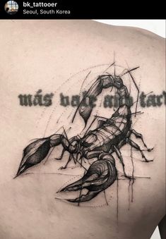 the back of a man's shoulder with an ink drawing of a scorpion on it