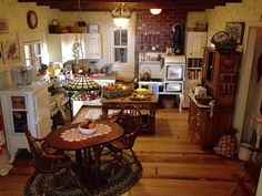 an open kitchen and dining room with wood floors, white appliances and wooden flooring